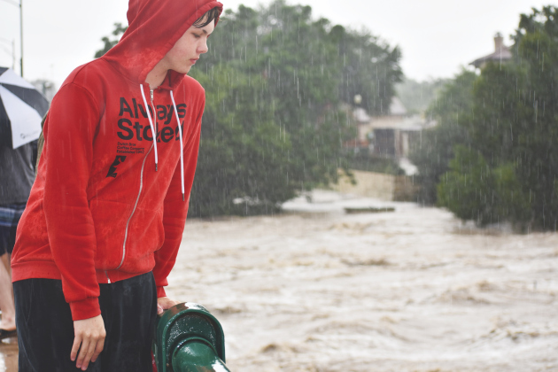 Hawkins Johnson, 16, sizes up the roaring San Gabriel River from the Austin Avenue bridge Saturday, July 5. Photo by Katherine Hamilton