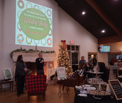 Rob Dyer, CEO of The Georgetown Project (center), is joined by Melissa Seigman, community engagement coordinator (left), at the nonprofit’s first Wreath Auction and Holiday Party, December 1. Photo by Nalani Nuylan.