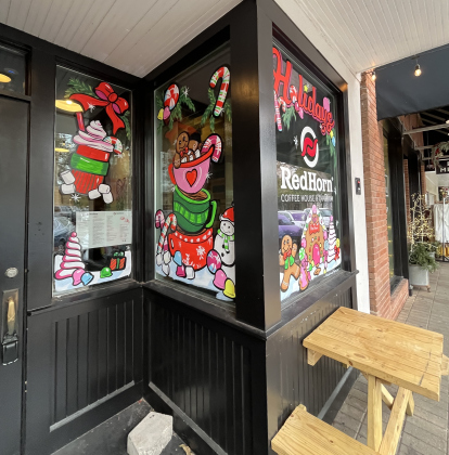 Red Horn Coffee House & Tap Room has holiday art painted on its windows. 