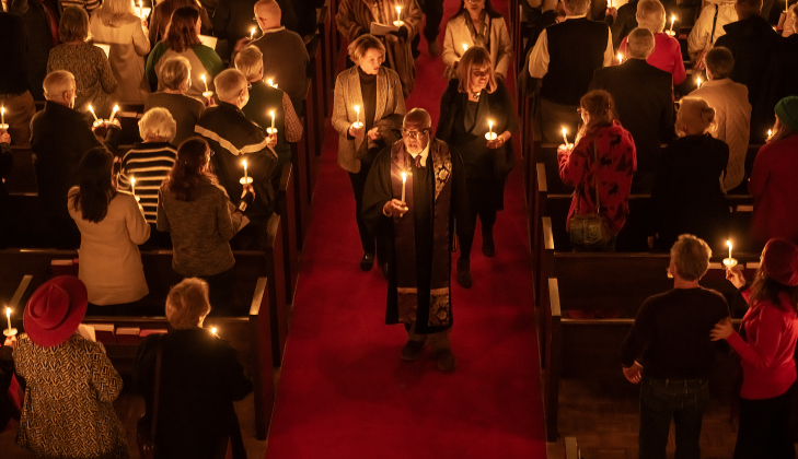 Reverend Dr. Ronald L Swain, at front in center aisle, leads a processional through the chapel lighted by candlelight during the Southwestern Candlelight Service, The Service of Lessons and Carols, held at Southwestern’s Lois Perkins Chapel on Thursday, December 4, 2025.  Dr Swain is Southwestern’s Chaplain and Director of Spiritual Life.  This was during the first of two services.  Originally called the Christmas Carol Service, the service began in 1915 at the University.    Photo by Andy Sharp.