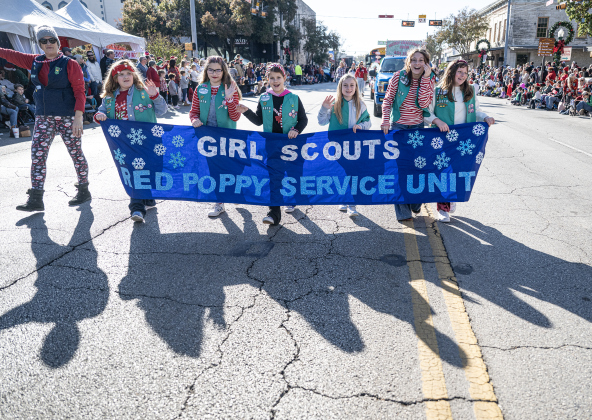 Members of the Girl Scouts Red Poppy Service Unit take part in the parade along Austin Avenue during the annual Christmas Stroll, held in downtown Georgetown on Saturday, December 6, 2025.   Photo by Andy Sharp.