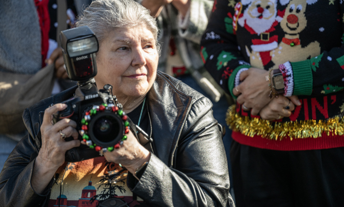 Yolanda Travis takes photographs during the parade along Austin Avenue during the annual Christmas Stroll, held in downtown Georgetown on Saturday, December 6, 2025.   Photo by Andy Sharp.