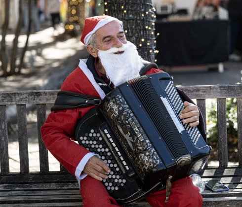 Drogo Sevo plays Christmas songs on his accordion at 8th and Main Streets  during the annual Christmas Stroll, held in downtown Georgetown on Saturday, December 6, 2025.   Photo by Andy Sharp.