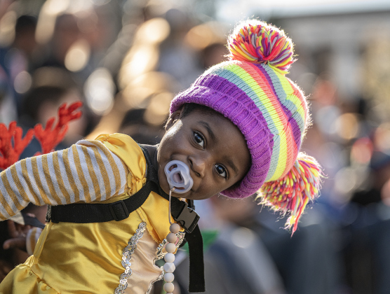 Dressed as Belle from Beauty and the Beast, 3-year-old Zychia Jones watches the Christmas Stroll parade.