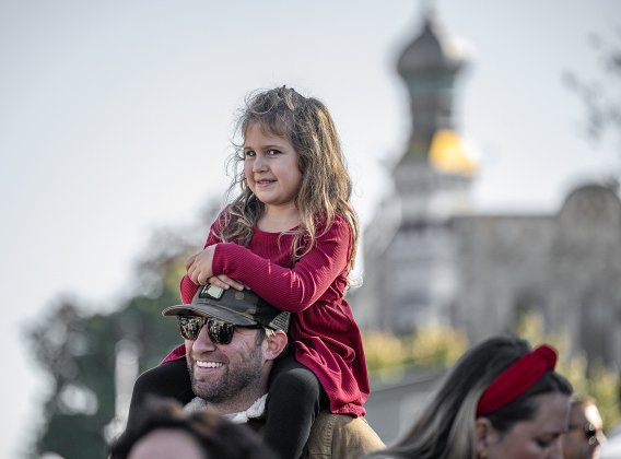 4-year-old Moxie Hutt utilized the shoulders of her dad, Dr. Brad Hutt, to watch the parade from 7th Street and  Austin Avenue during the annual Christmas Stroll, held in downtown Georgetown on Saturday, December 6, 2025.   Photo by Andy Sharp.