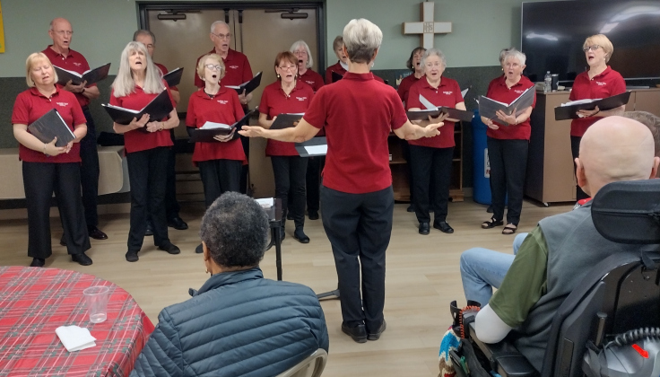 Singers from the Heritage Oaks Chorus, led by Kathleen Bohn, performed Christmas favorites on Wednesday, December 3, during A Gift of Time’s weekly respite at St. John’s Methodist Church. The choir consists of members who live in the Heritage Oaks neighborhood, near the intersection of Williams Drive and Shell Road. The chorus will host a spring concert in May, open to the public at the Heritage Oaks clubhouse. 
