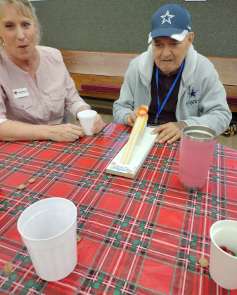 While Jeanette Workman watched, Henry Bracamontez tried his hand with the cookie catapult, flinging Cookie Crisp cereal miniature chocolate chip cookies toward a cup.
