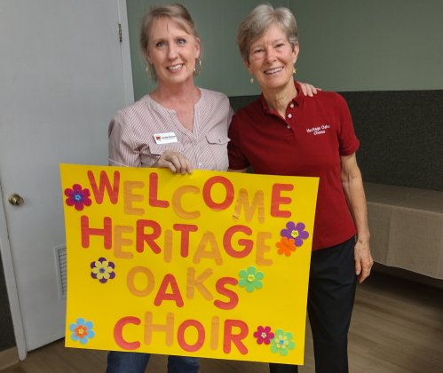 Gift of Time respite program leader Jeanette Workman (left) welcomed director Kathleen Bohn and the Heritage Oaks Chorus December 3. Chorus members sang carols during the Gift of Time weekly Wednesday respite at St. John’s Methodist Church.