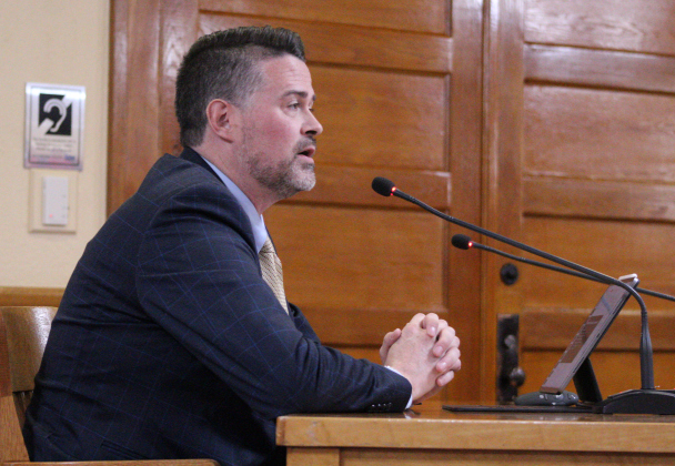 Cameron Glass, director of justice for Kitchell/CEM, Inc., presents the Phase 1 update for the new Jail and Justice Center during the December 17 County Commissioners Court meeting at the historic courthouse. Photo by Nalani Nuylan.