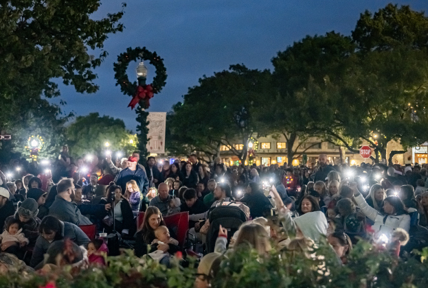 Attendees provided their own light as they waited for the  big lights to come on during the Lighting of the Square on Friday, November 28, 2025.  Photo by Andy Sharp.