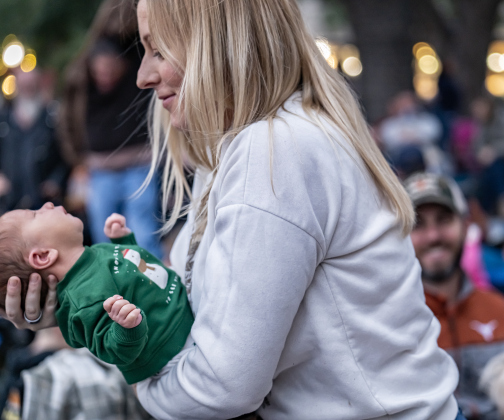 Kate Hill, with her 11-day-old son Oliver, attended  the Lighting of the Square  with her family on Friday, November 28, 2025.  Photo by Andy Sharp.