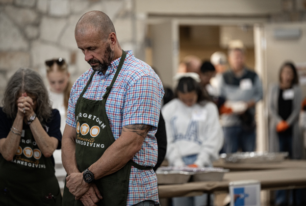 Georgetown Police Chief Cory Tchida joins others in prayer at the Georgetown Community Thanksgiving, held at the San Gabriel Community Center on Thursday, November 27, 2025.