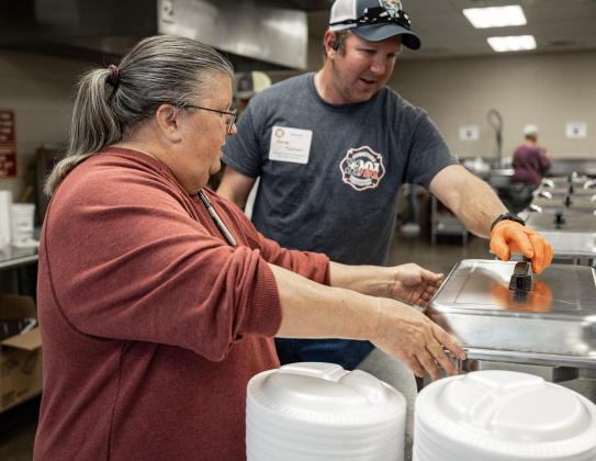 Alycia Tandy, left, one of the founders of the Georgetown Community Thanksgiving, works in the kitchen area with Georgetown firefighter Garey Jackson during the event held at the San Gabriel Community Center on Thursday, November 27, 2025.