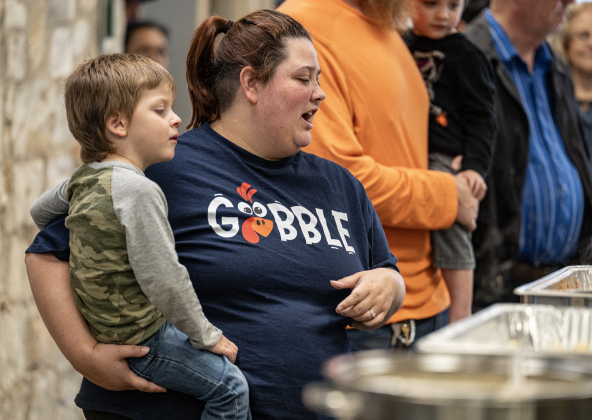Kamry Salyer and her son Owen, 3, look over selections in the serving line during  the Georgetown Community Thanksgiving, held at the San Gabriel Community Center on Thursday, November 27, 2025.