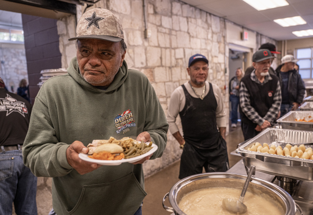 David Martinez, left, who is homeless, makes his way through the serving line during the Georgetown Community Thanksgiving, held at the San Gabriel Community Center on Thursday, November 27, 2025.