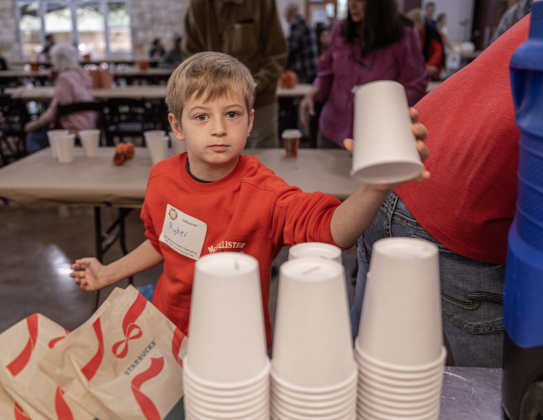 7-year-old Ryker Jones, whose father is a Georgetown firefighter, helps get drinks for attendees at the Georgetown Community Thanksgiving, held at the San Gabriel Community Center on Thursday, November 27, 2025.