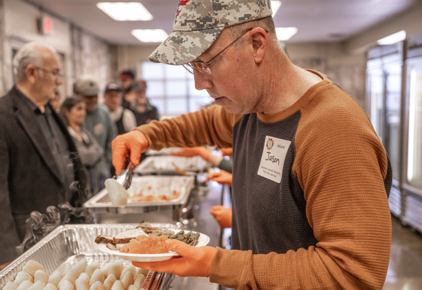 Georgetown firefighter Jason Fryer helped distribute plates to attendees  during the Georgetown Community Thanksgiving, held at the San Gabriel Community Center on Thursday, November 27, 2025.  