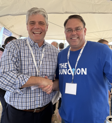 Georgetown City Manager David Morgan (left) shakes hands with Drew Hall, whose family has owned the property.