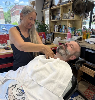 Esin Lau, founder of Georgetown Barbershop, shaving Council Member Kevin Pitts’ beard. Photo by Abbey Archer