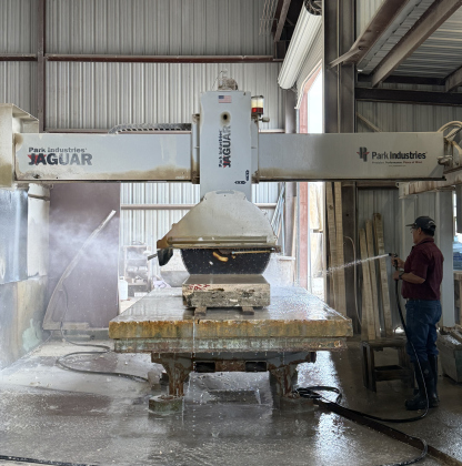 A Jaguar Bridge Saw then cuts the rock into final precise dimensions. An employee sprays it with water to keep the blade cool, reduce dust and produce a smoother cut.