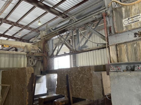 Step one of the stone-cutting process uses a large block saw that cuts large chunks of stone into more manageable pieces.