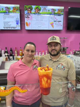 Owners of La Vaquerita Creamery, Yozoe Delatorre and Modesto Arismendi, show off a Mangonada— their best seller. 