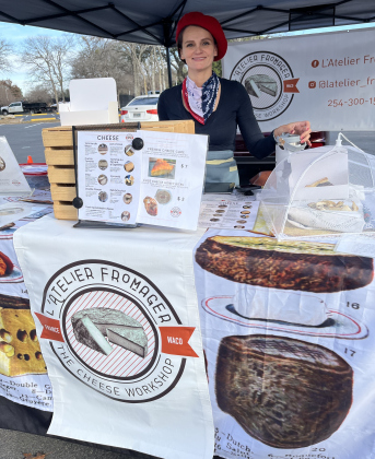 Katharine Nurra shows off her cheese from L’Atelier Fromager. Photos by Linda Dwyer