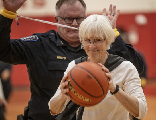 Georgetown Assistant Police Chief Roland Waits tries to block a shot by Texas Fire Ants player Terri Blackledge as the the police department takes on the  Granny Basketball Team, the Texas Fire Ants, during a matchup held at East View High School on Saturday, January 17, 2026.  Members of the police department wore bands connecting their arms to even up the game for the Fire Ants.  The game, won by the Fire Ants, with a final score of 55-47,  benefits the Carver Center for Families.      Photo by Andy Sharp