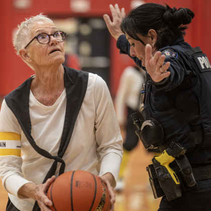 Texas Fire Ants player Judy Hanes, 81, left, is matched against Georgetown Police Department officer Shannon Hall during a matchup held at East View High School on Saturday, January 17, 2026.  The game, won by the Fire Ants, with a final score of 55-47,  benefits the Carver Center for Families.      Photo by Andy Sharp.