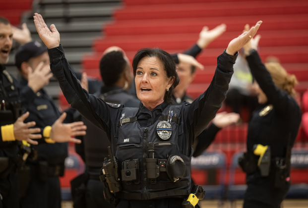 Georgetown Police Department officer Shannon Hall acknowledges the audience  as the the police department takes on the  Granny Basketball Team, the Texas Fire Ants, during a matchup held at East View High School on Saturday, January 17, 2026.  The game, won by the Fire Ants, with a final score of 55-47,  benefits the Carver Center for Families.      Photo by Andy Sharp.