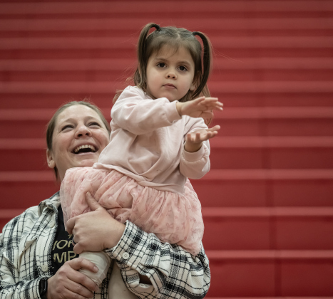 2-year-old Noah Ellis, with her aunt Cristen Jonse, cheers on the teams during a matchup pitting the Texas Fire Ants Granny Basketball Team against the Georgetown Police Department,  held at East View High School on Saturday, January 17, 2026.   Noah’s aunt, Kandice Ellis, is a Georgetown Police Department officer.  The game, won by the Fire Ants, with a final score of 55-47,  benefits the Carver Center for Families.      Photo by Andy Sharp.