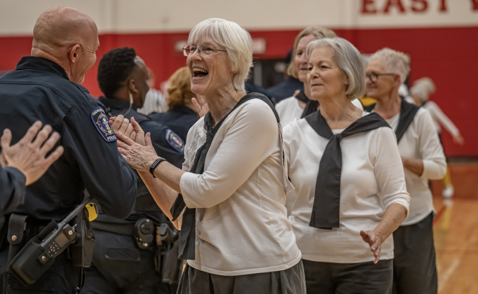 Texas Fire Ants team member Terri Blackledge high-fives members of the Georgetown Police Department  team after the Fire Ants won  55-47 at East View High School on Saturday, January 17, 2026.  The game  benefits the Carver Center for Families.      Photo by Andy Sharp.