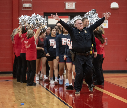 Georgetown Assistant Police Chief Roland Waits leads his team onto the court as the the police department takes on a  Granny Basketball Team, the Texas Fire Ants, during a matchup held at East View High School on Saturday, January 17, 2026.  The game, won by the Fire Ants, with a final score of 55-47,  benefits the Carver Center for Families.      Photo by Andy Sharp.