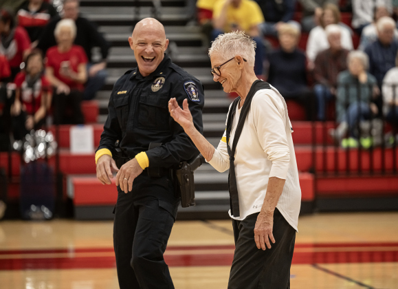 Georgetown Police Department Commander Erik Grasse enjoys time on the basketball court with 81-year-old Judy Hanes as the the police department takes on a Granny Basketball Team, the Texas Fire Ants, during a matchup held at East View High School on Saturday, January 17, 2026.  The game, won by the Fire Ants, with a final score of 55-47,  benefits the Carver Center for Families.      Photo by Andy Sharp.