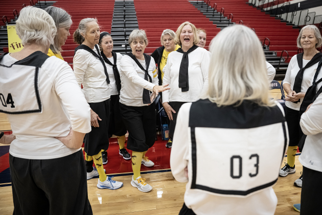Texas Fire Ants team member Geri Foster (center, gesturing)  gives encouragement to teammates during a brief timeout as their  Granny Basketball Team took on members of the Georgetown Police Department  during a matchup held at East View High School on Saturday, January 17, 2026.  The game, won by the Fire Ants, with a final score of 55-47,  benefits the Carver Center for Families.      Photo by Andy Sharp.