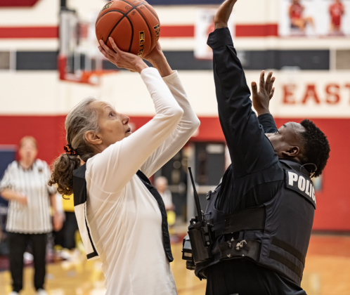 Texas Fire Ants team member Irma Sanchez tries a shot over Georgetown Police Department officer Erron Oliver, right, as this  Granny Basketball Team took on members of the Georgetown Police Department during a matchup held at East View High School on Saturday, January 17, 2026.  The game, won by the Fire Ants, with a final score of 55-47,  benefits the Carver Center for Families.      Photo by Andy Sharp.