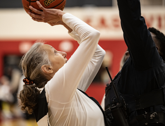 Texas Fire Ants team member Irma Sanchez, left, attempts a shot over the head of Georgetown police officer Erron Oliver during a Granny Basketball Team matchup against the Georgetown Police Department held at East View High School on Saturday, January 17, 2026.  The game, won by the Fire Ants, with a final score of 55-47,  benefits the Carver Center for Families.      Photo by Andy Sharp.