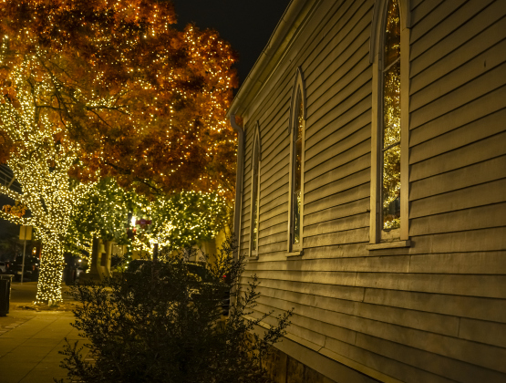 A tree covered in holiday lights falls on the facade of Grace Heritage Center on Tuesday, December 16, 2025.   Seasonal lights are abundant in Downtown Georgetown this year.  Photo by Andy Sharp.