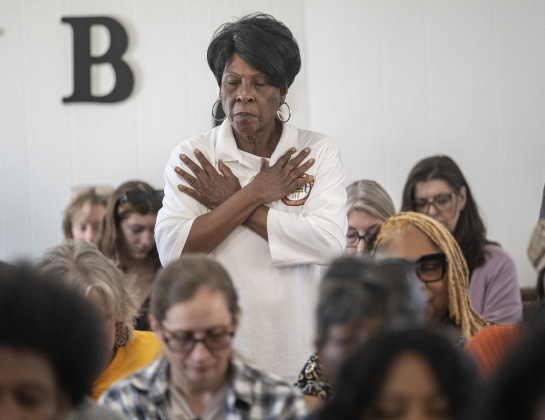 Patricia Bailey joins others in prayer during the invocation by Rev. Jerome Curry, Pastor at St. Paul United Methodist Church during the Dr. Martin Luther King Jr. Day annual march and program on Monday, January 19, 2026.  The program was held at Macedonia Baptist Church.  The day’s events were coordinated by the Georgetown Fellowship of Churches.