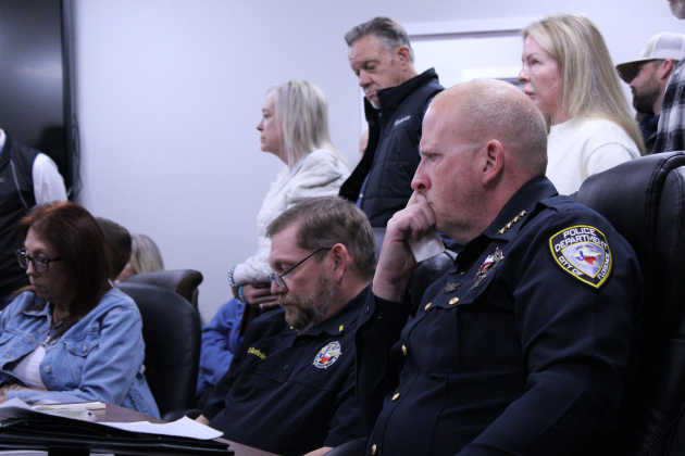 Florence Police Chief Wayne Thompson, right, gets tearful listening to 15 people vocalize their support of him during the January 20 special-called city council meeting. Photo by Nalani Nuylan.