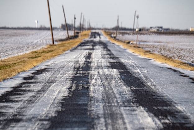 Large patches of ice cover portions of County Road 347 south of Granger on Monday afternoon, January 26, 2026.  This was a little after 5 p.m..The temperature reached the low-mid 30s Monday, but was expected to dip to 14 degrees by Tuesday morning.   Photo by Andy Sharp.