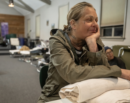 Brittany Wright enjoys the warmth inside  the Getsemani Center on Friday night, January 23, 2026.  With winter weather coming to Central Texas, the area’s homeless find shelter at warming centers in the area.    Photo by Andy Sharp.