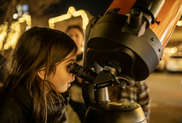 Hannah Bajar, 5, is pictured at 8th and Main Streets as she looks at the Waxing Gibbous moon through a telescope brought by Brad Sloan  on Wednesday, December 31, 2025, New Years Eve in Georgetown.   Photo by Andy Sharp.