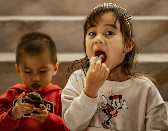 2-year-old Leo Chung and his sister Lyanna, 4, enjoy cupcakes while sitting with their parents on the steps of the Williamson County Courthouse on Wednesday, December 31, 2025, New Years Eve in Georgetown.   Photo by Andy Sharp.
