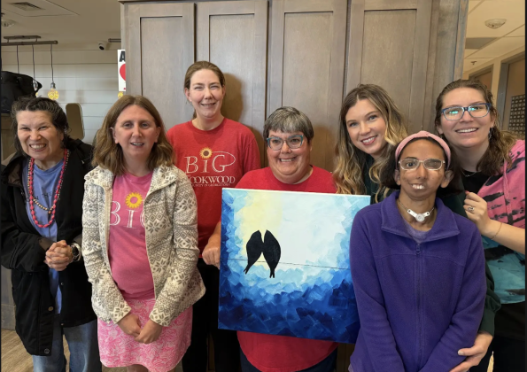 BiG citizens standing with a bird painting they are working on. (From left to right) Debbie, Brittany, Mary Catherine, Michelle, Elizabeth Griffin CEO, Beth, Kylie. Photo by Abbey Archer