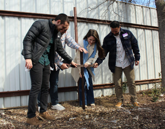 Pastors Jordan Geist, far left, Nathan Brown, center left, a pastor from Celebration's Leander/Liberty Hill campus, center right, and Shawn Martinez stake a cross on Yesterday’s Gone expanded property as part of the Blessing of the Land Ceremony, January 29. Photo by Nalani Nuylan.
