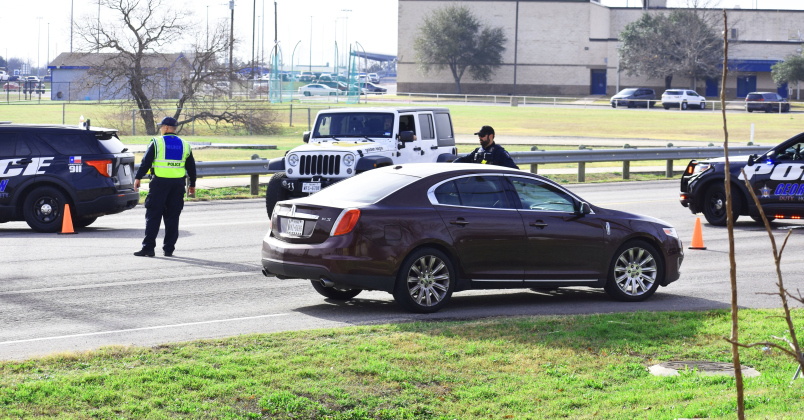 Georgetown law enforcement officers steer Austin Avenue traffic away from Georgetown High School Wednesday morning during a school lockdown.  Photo by Katherine Hamilton