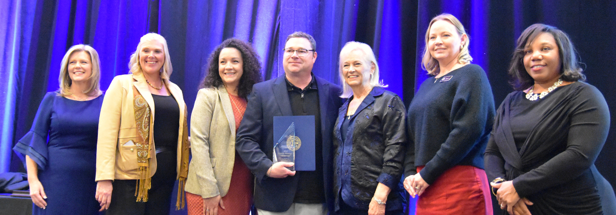 Sun City Texas won Large Business of the Year at the Georgetown Chamber of Commerce’s annual awards on January 30. Josh Lockhart, center, executive director of Sun City Texas, was joined on stage by other members from the Sun City Community Association, Georgetown Chamber of Commerce president Shontel Mays, far left, and one of last year’s winners, Angela Cornelius, far right.