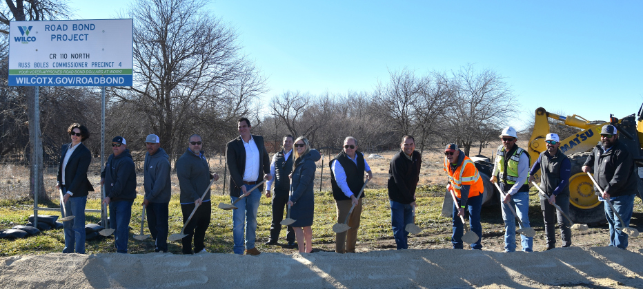 From left: Liviu Reynolds, FLAG; Todd Glanville, City of Georgetown; Daniel Hernandez, City of Georgetown; Lua Saluone, City of Georgetown; Dave Jones, RPS; Kate Wilder, HNTB; Commissioner Russ Boles, Precinct 4; Oscar Salazar-Bueno, HNTB; John Russell, HNTB; Andrew Batten, Joe Bland Construction; Will Byerly, Joe Bland Construction; and Steven Shull, HNTB at the groundbreaking for County Road 110 North. (Photo by Kaitlyn Wilkes)