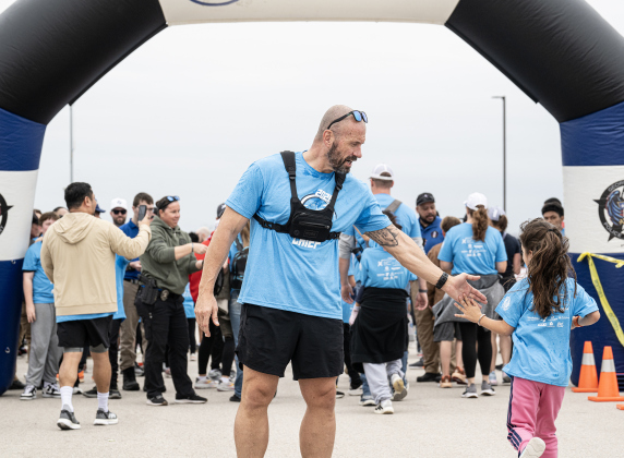 Police Chief Cory Tchida congratulates Fun Run finishers during the annual Chase The Chief races held at East View High School on Sunday, March 8, 2026.
